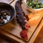 Lodge_Food_5-150x150 Cooked meat, a dollop of red sauce, and a bowl of Brussels sprouts