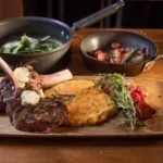 Lodge_Food_6-150x150 Cooked meat with herbs, a potato cake, and sautéed vegetables