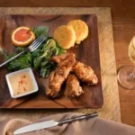 Lodge_Food_7-150x150 A square plate with fried chicken, greens