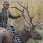 Hunter posing with large elk