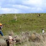 Hunters aiming at a distant target.