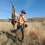 Hunter proudly holding game trophy