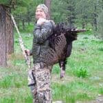 Hunter with turkey in wilderness