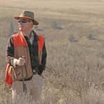 A hunter poses in the field